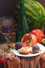 Red wine with a pomegranate and a fig