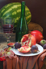 Red wine with a pomegranate and a fig