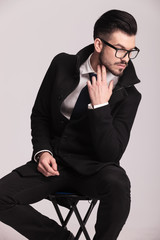 Handsome elegant business man sitting on a stool