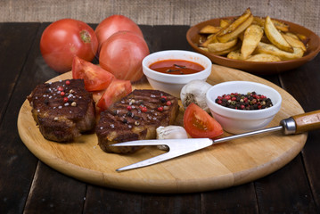 Beef Steaks with Sauce, French Fries and Vegetables