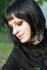 Naklejka premium Beauty goth girl walks in park