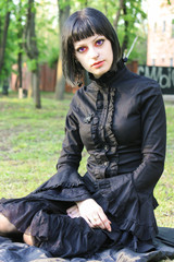 Beauty goth girl walks in park