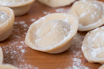 Homemade raw pastry dumplings with meat filling called pelmeni