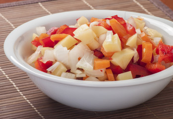 Raw vegetable cut in wooden background close up