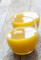 Glass of freshly pressed orange juice close up