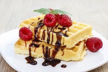 Waffles with chocolate and raspberries