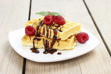 Waffles with chocolate and raspberries