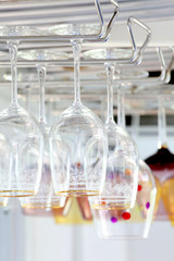 empty glasses hang from above