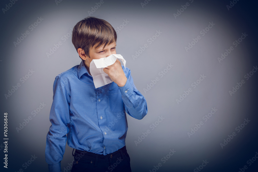 Wall mural teenager boy of 10 years European appearance sick sneezing in