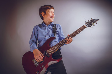 teenager boy of 10 years European appearance smiles plays gui