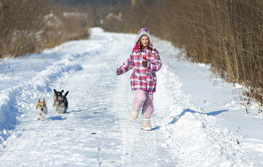 Fototapeta na wymiar Girl with dogs on snow