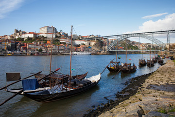 Fototapeta na wymiar Boats on Douro River and Porto Skyline in Portugal