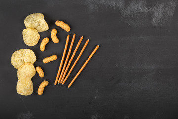 Snacks on dark chalkboard with copy-space
