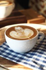 vintage color tone of  cup of coffee with red heart on the table