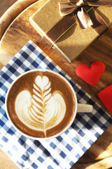 vintage color tone of  cup of coffee with red heart on the table
