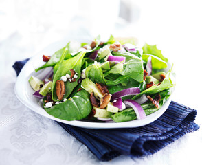 spinach and avocado salad on white plate