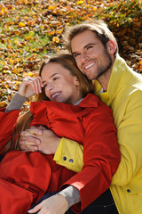 Portrait of beautiful happy couple - park, autumn, leaves