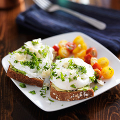 breakfast with toast and poached eggs on top of avocado
