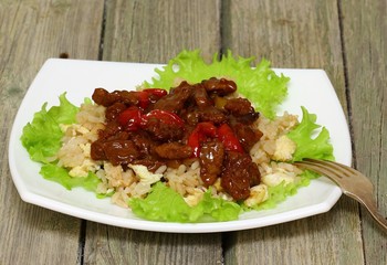 Asian food - roast meat with vegetables and rice