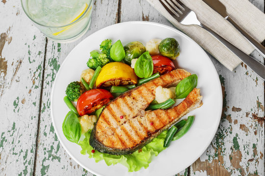 steak grilled salmon with vegetables on a plate