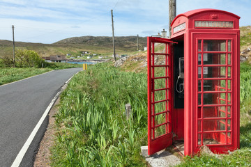 Fototapeta na wymiar Red phone booth in scottish countryside