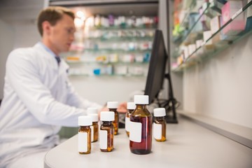Pharmacist using computer at desk