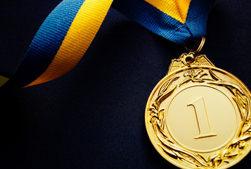 Gold medal on a dark blue background
