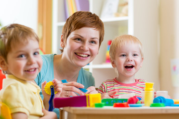 woman playing and teaching children