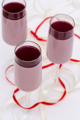layered cranberry mousse in glass on white table