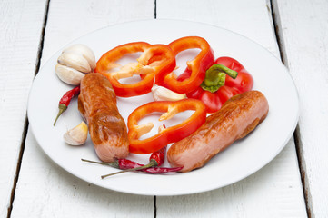 Grilled sausages with pepper on plate