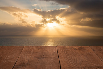 Wood flooring with a view of the sunset over the sea