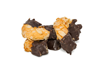 Biscuits halfway into chocolate half nuts