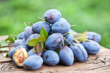 Plums on an old wooden table.