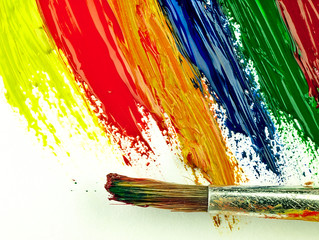 Color traces and brush on a white sheet of paper.
