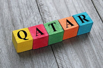 word qatar on colorful wooden cubes