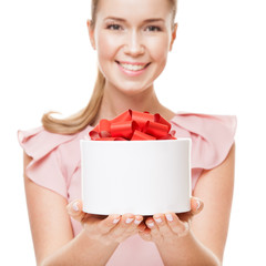 Young happy smiling woman with a gift in hands. Focus on the gif