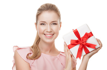 Young happy smiling woman with a gift in hands. Isolated on whit