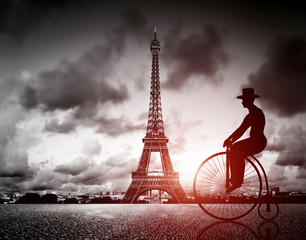 Man on retro bicycle next to Effel Tower, Paris, France. - obrazy, fototapety, plakaty