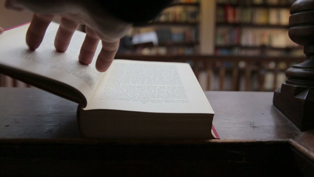 man reading in book inside old library