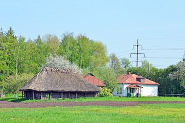 Fototapeta na wymiar Ancient traditional ukrainian rural wooden barn and hut