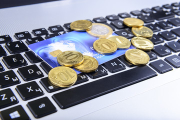coins and a bank card on the keyboard