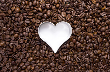 Hundreds of coffeebeans with a heart cutter