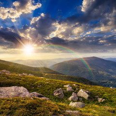 mountain hillside with white boulders at sunset