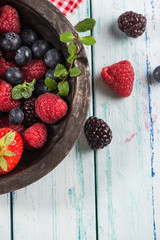 Rustic bowl with fresh summer berries fruits