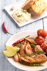 A plate of boiled shrimp with tomatoes