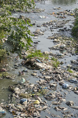 Fototapeta na wymiar Garbage in water sacred hinduism Bagmati river.