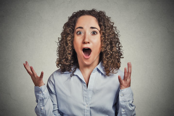 Surprise astonished woman isolated on grey background 