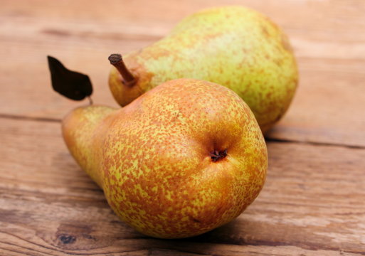 Two pear on wooden background