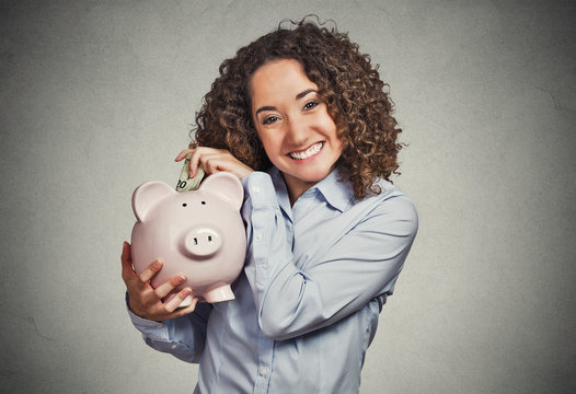 smiling business woman employee student holding piggy bank