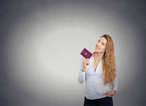 smiling happy woman standing holding passport looking up imagini